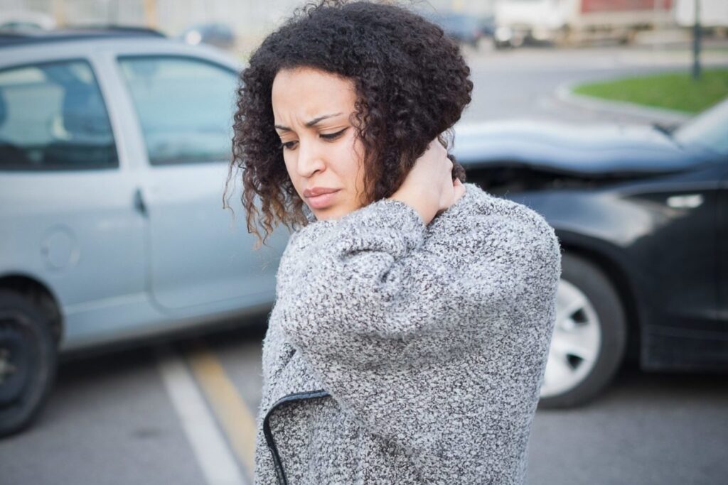 Image of a woman has a pain in neck after a car accident