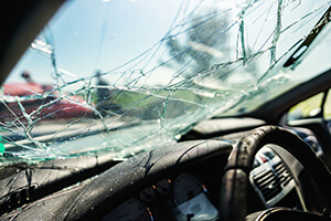 Closeup image of crashed car window in car accident.