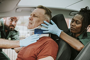 Image of a man in a car accident resulting in serious neck injury