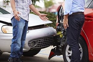 Image of an At Fault Driver Inspecting Damage