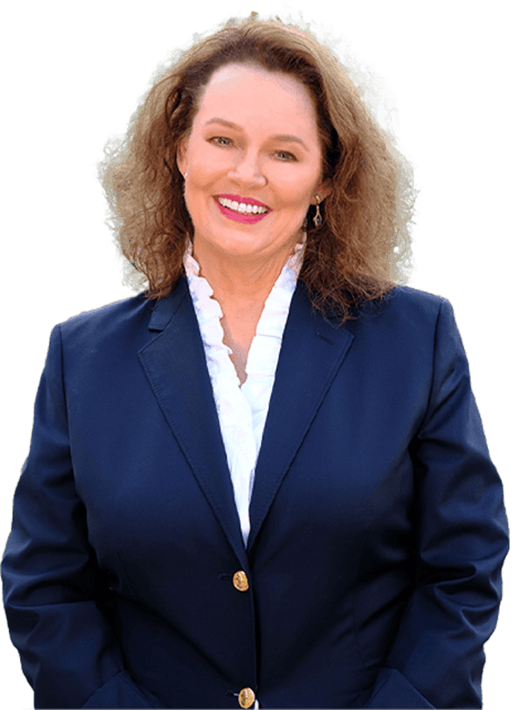 Woman with curly brown hair wearing a navy blazer and white blouse, smiling at the camera against a plain background.
