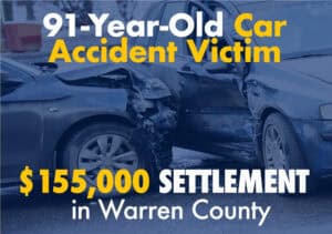 Two damaged cars after a collision, with text stating a 91-year-old car accident victim received a $155,000 settlement in Warren County.