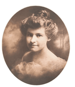 Sepia-toned portrait of a young woman with an updo hairstyle, wearing a light, sheer garment, looking slightly to the side and smiling faintly, reminiscent of early portraits such as those of Judge Clay Elliott.